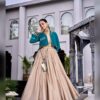 Side view of the beige Chhabili skirt with the teal jacket and beaded edging