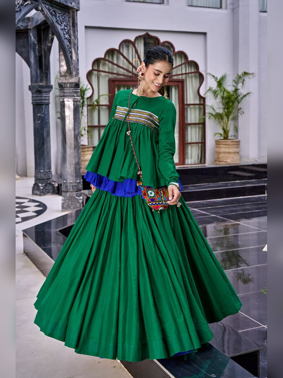 Side view of the green Chhabili chaniya choli with blue frill under the peplum