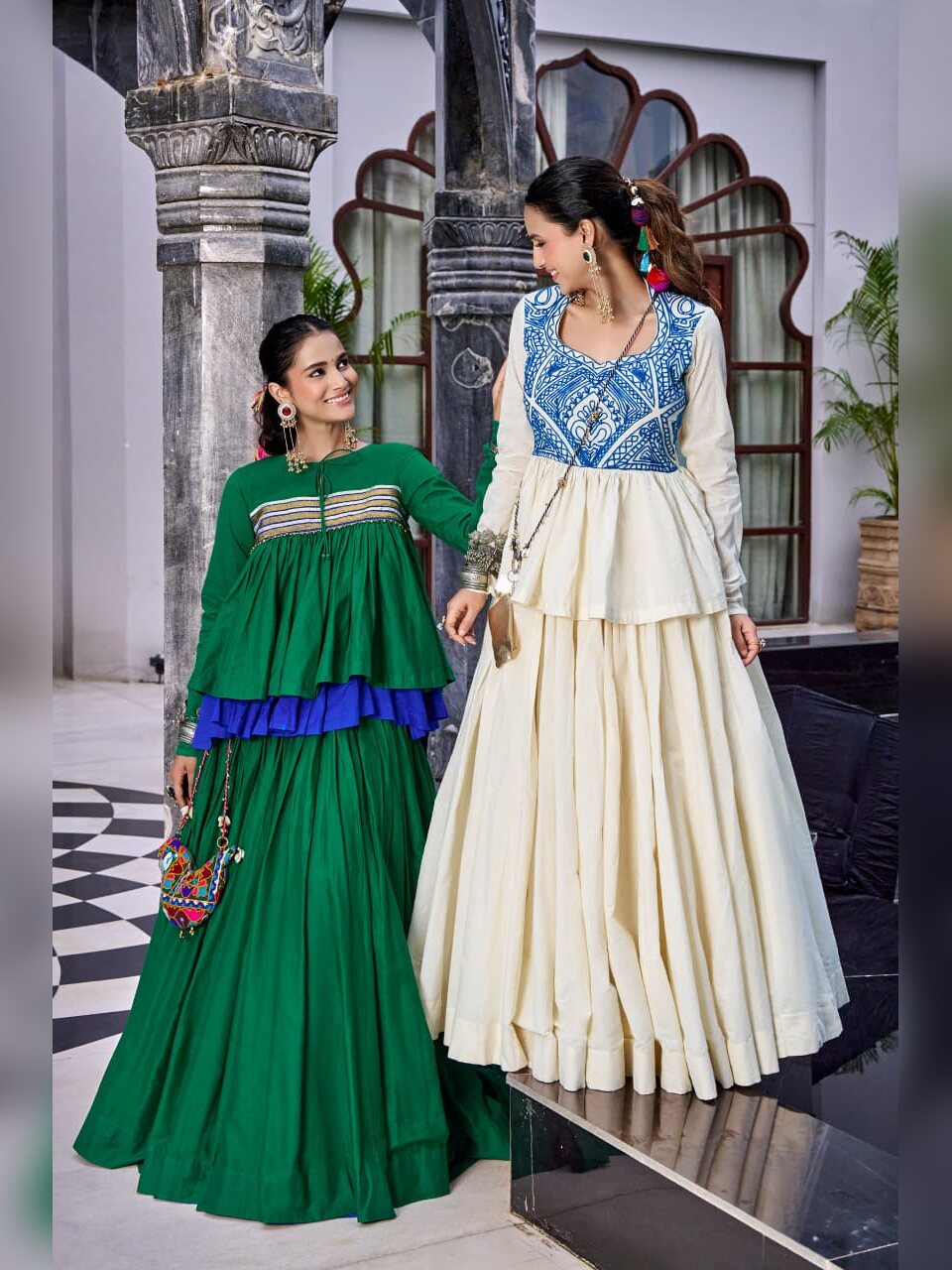Two models wearing the Chhabili Navratri chaniya choli in green gota and off white Kashida