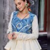 Close up of blue Kashida embroidery across the off white peplum top