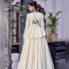 Back view showing blue parrot embroidery on the off white peplum top