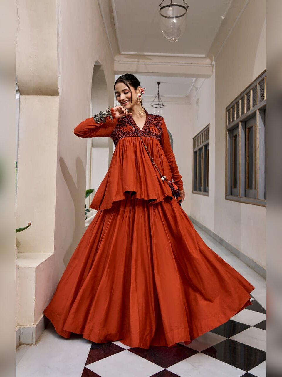 Rust pure cotton Navratri chaniya choli with navy Kashida work peplum top and matching purse
