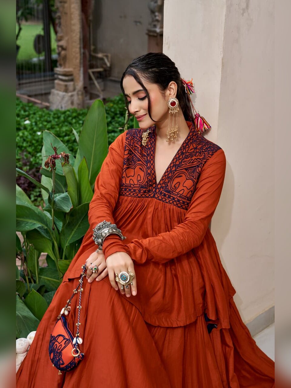 Close up of navy Kashida elephant motifs on the rust Chhabili peplum top