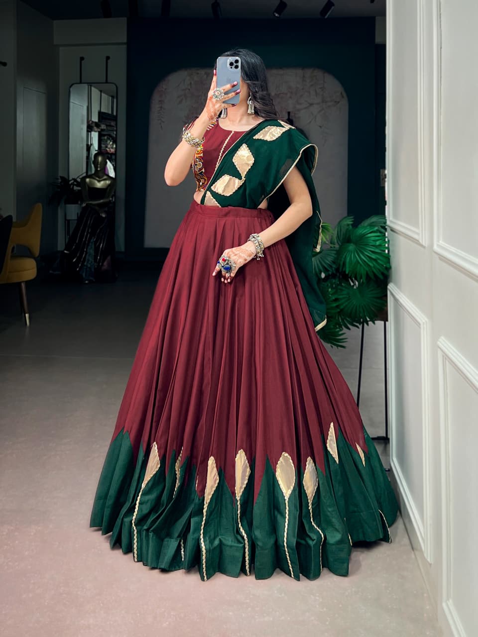 Maroon chinon Navratri chaniya choli with green georgette dupatta draped