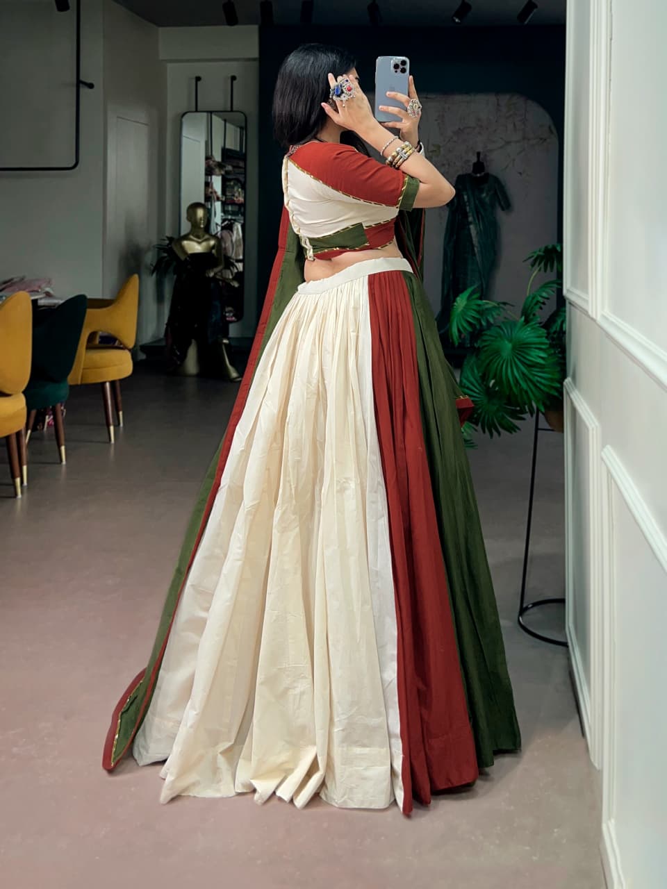 Back view of the mehendi green and off white panelled cotton lehenga