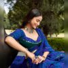 Close up of round mirror work on the green blouse and the leheriya dupatta border