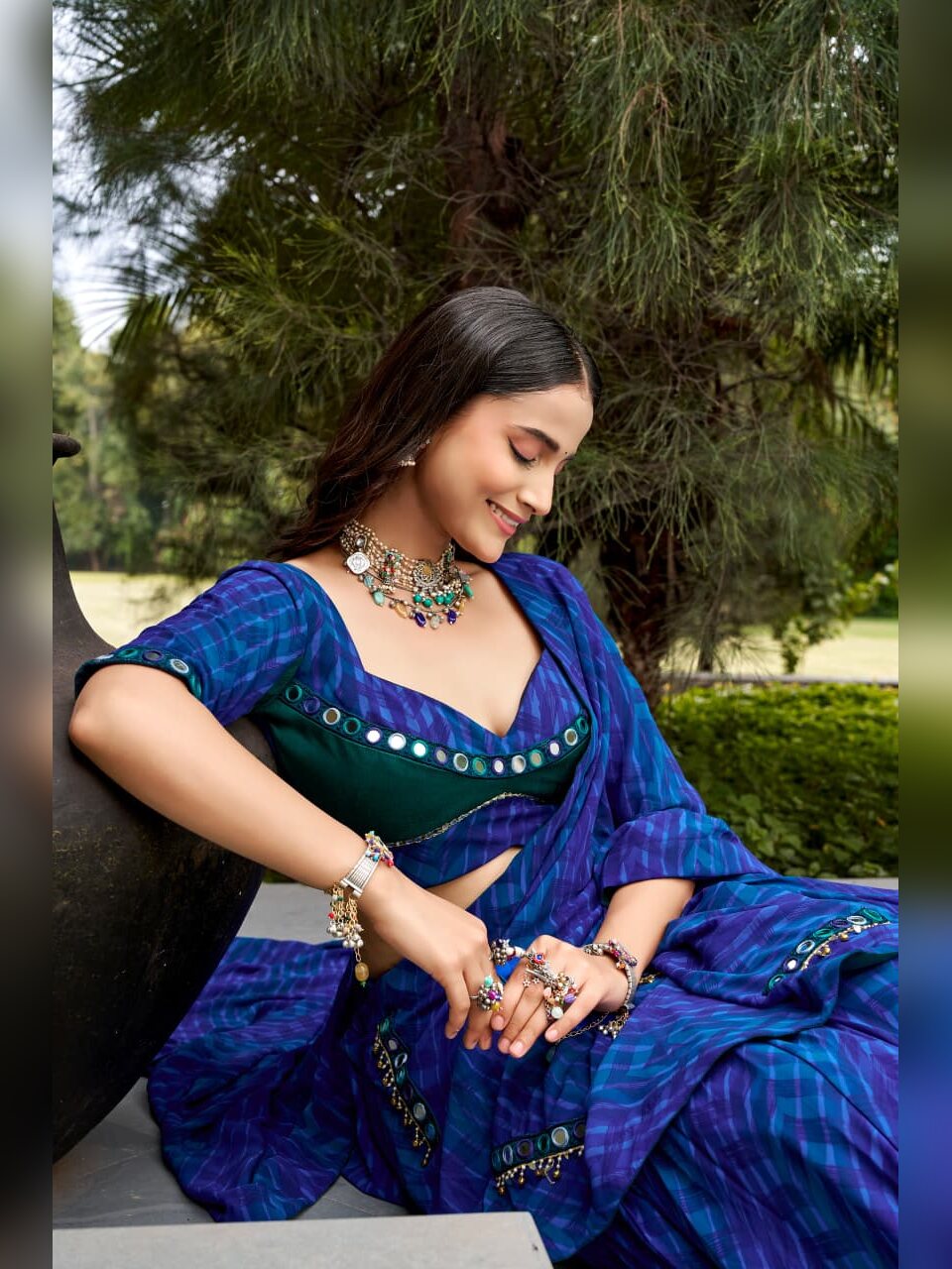 Close up of round mirror work on the green blouse and the leheriya dupatta border