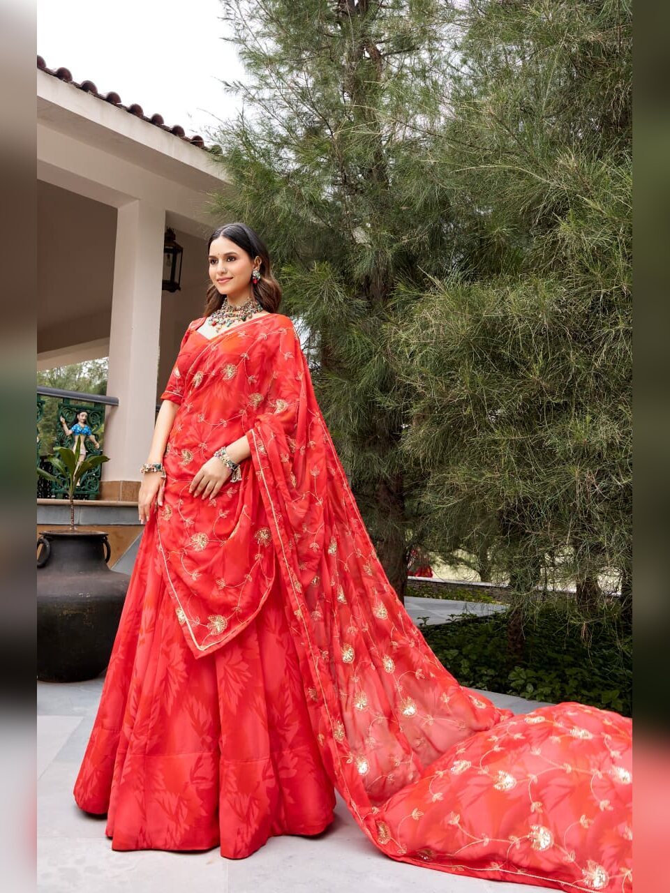 Full length view of the red Morbani lehenga with the embroidered dupatta trailing