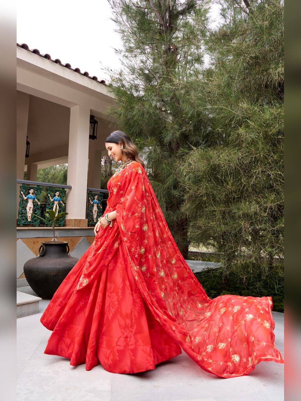 Red sheer dupatta with gold floral vine embroidery over the red georgette lehenga