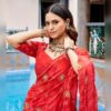 Close up of gold sequin and thread floral embroidery on the red Morbani dupatta