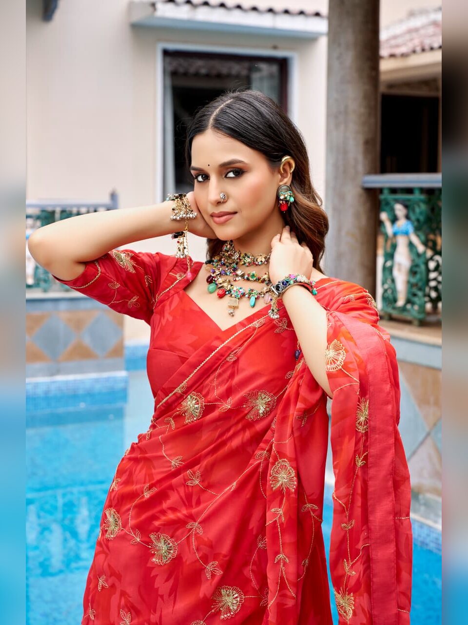 Close up of gold sequin and thread floral embroidery on the red Morbani dupatta